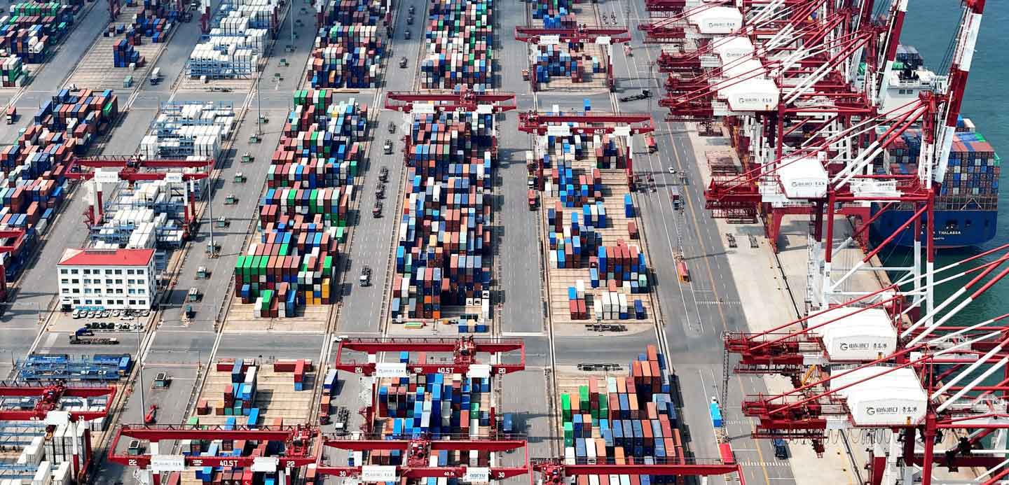 A shipyard with containers and cranes A shipyard with containers and cranes