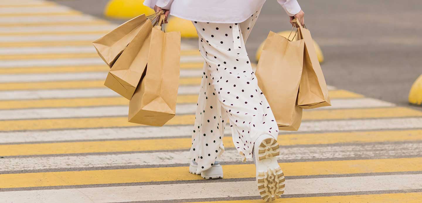 Person walking with paper shopping bags Person walking with paper shopping bags